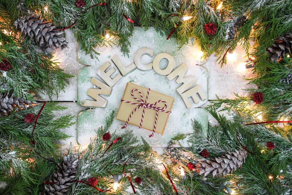 Holiday welcome sign with brown paper package